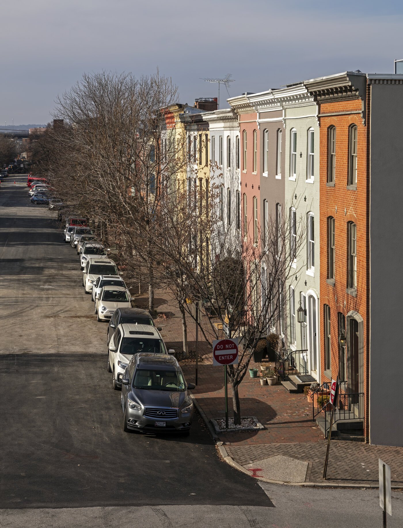 A street of brick and painted rowhouses in Baltimore